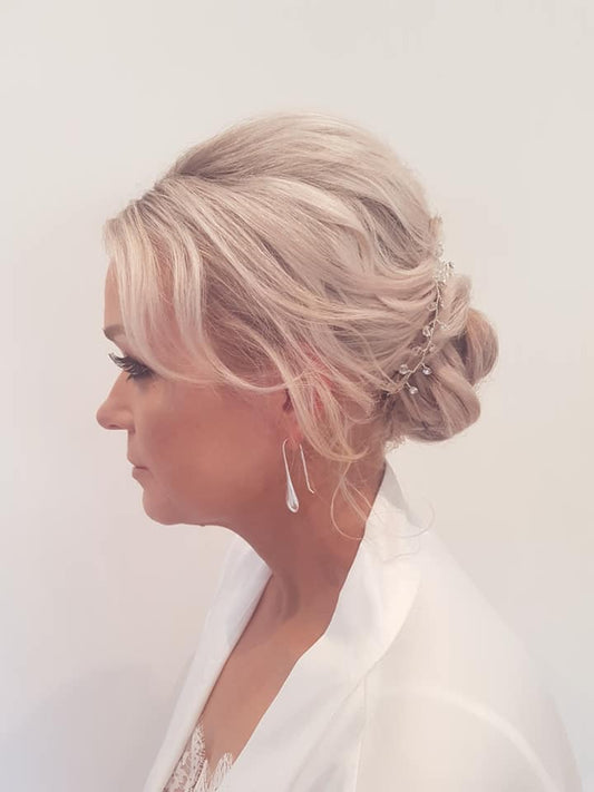 Soft  low bun with braid down top